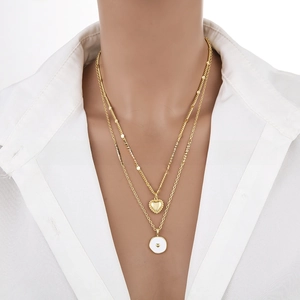 Detail view of 18K gold plated double layer necklace with heart and round enamel pendant