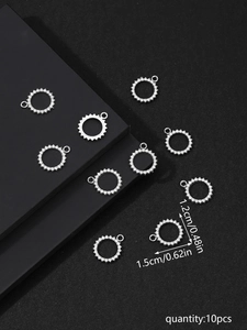 Detailed size view of silver rhinestone sun pendants with 1.5cm outer diameter