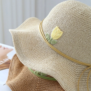 Straw sun hat with yellow tulip embroidery and foldable wide brim for beach travel
