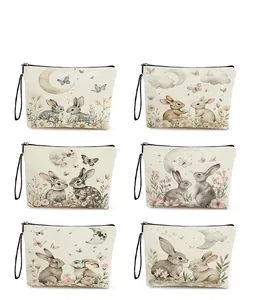 Detailed pattern display of canvas cosmetic bags with bunny designs and zipper