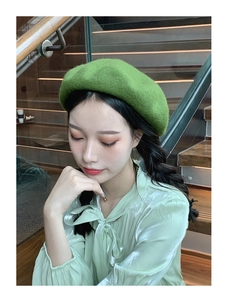 Detail of wool grass green beret on model showing premium texture and fashion fit