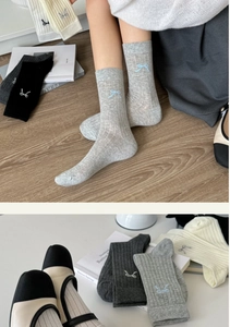 Detailed view of grey ballet style cotton socks featuring a delicate bow embroidery detail