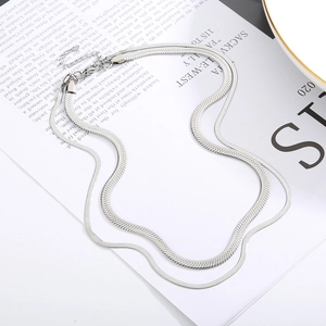 Detail of silver double-layered snake bone flat chain necklace with lobster clasp