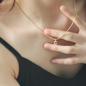 Gold snake chain necklace with sparkling zircon letter C pendant shown on model