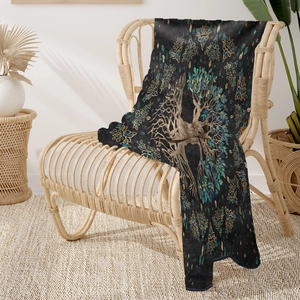 Detail of soft flannel throw blanket featuring a colorful Tree of Life art design