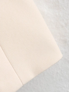 Macro close-up of premium beige fabric showing detailed twill texture and soft material