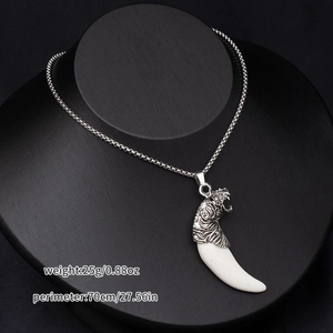 Detailed tiger head and wolf fang pendant necklace on professional mannequin display