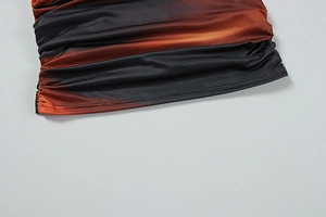 Detail of red and black gradient fabric featuring elegant ruching and fine stitching