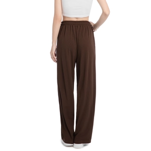 Detail view of the brown ribbed corduroy fabric and elastic waistband on wide leg pants