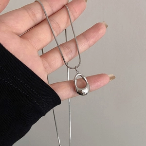 Silver irregular oval pendant necklace featuring a minimalist liquid metal fluid design