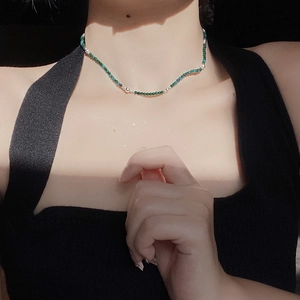 Minimalist S925 silver and green turquoise beaded necklace worn with artistic lighting