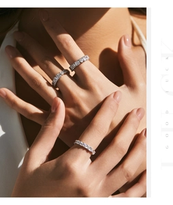 Close-up of three stacked S925 silver eternity rings with sparkling CZ stones on hand