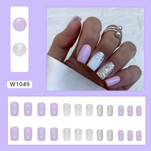 Lavender purple press-on nail kit with silver glitter and white gradient design pieces