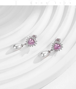 Detail of s925 silver drop earrings with pink heart gemstone and teardrop pearl
