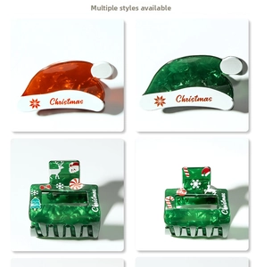 Detail view of glossy Christmas hair claws featuring reindeer, snowflakes and candy cane motifs