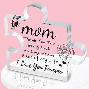 Macro shot of puzzle-shaped acrylic plaque for mom with pink floral print and text