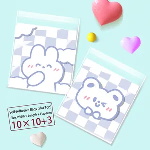 Close-up of 10x10+3cm transparent self-adhesive bags with purple checkered cartoon patterns