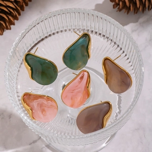 Gold-rimmed chunky resin teardrop earrings in green, pink, and brown marble patterns
