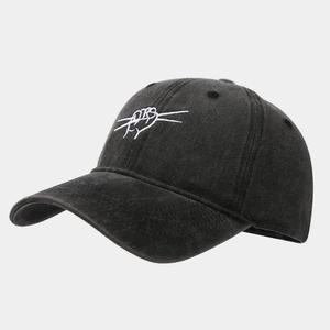 Close-up of artistic white embroidery on a washed black cotton six-panel baseball cap