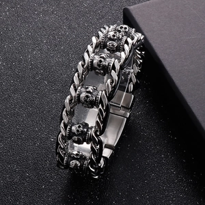 Vintage braided leather and stainless steel skull bracelet with a rugged chain design