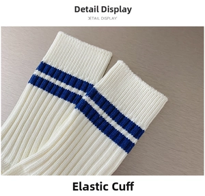 Detail display of white combed cotton socks showing elastic cuffs with blue stripes