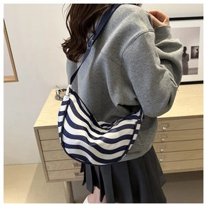 Detail of adjustable strap and blue white wave pattern on nylon dumpling bag