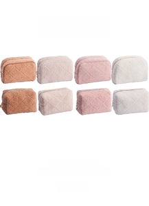 Close-up of quilted teddy fleece cosmetic bags in brown, beige, pink, and white colors