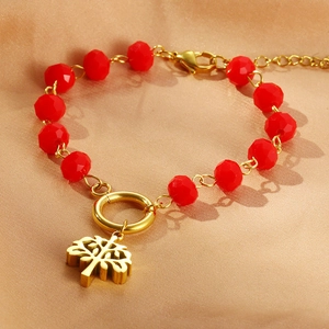 Red crystal beads bracelet with golden Tree of Life pendant on champagne silk fabric
