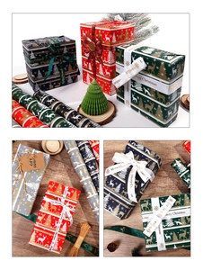 Detail of Christmas gift wrapping paper rolls with festive ribbons and Merry Christmas tags