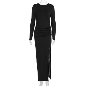 Detail view of the elegant ruched waist and side slit on this slim fit black maxi dress