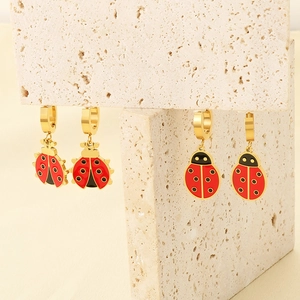 Chic gold-plated stainless steel ladybug hoop earrings with red enamel on stone stand