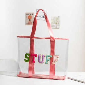 Large clear PVC tote bag with pink straps and colorful STUFF towel embroidery