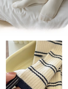 Detailed texture of cotton striped socks with ribbed fabric in beige and white