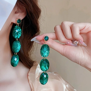 Vintage emerald green drop earrings with gold faceted oval crystals and silver needles
