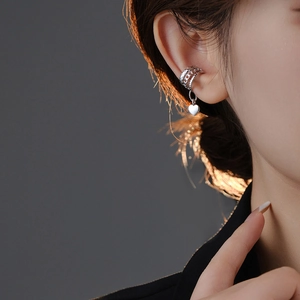 Detail of silver heart ear cuff on model showing multi-layer design without piercing