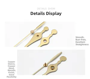 Macro detail of gold clock hands with copper bushings showing smooth metal texture