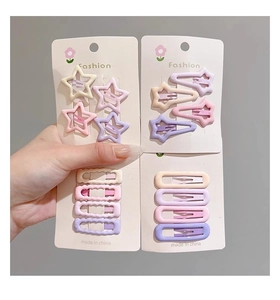 Close-up of colorful macaron star and waterdrop hair clips in fashion packaging