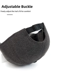 Detail of adjustable plastic buckle and textured fabric on the back of the grey baseball cap