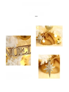 Detailed view of gold ornaments, glitter stars, and wooden Noel sign for Christmas tree