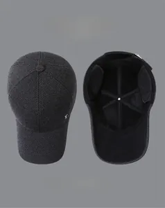 Detailed view of winter baseball cap showing textured fabric and hidden ear flaps