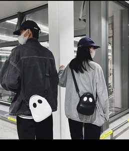 Rear view of a ghost-shaped PU leather crossbody bag in black and white street style