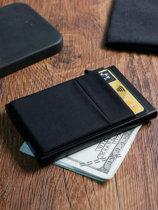 Minimalist black RFID metal wallet detail showing premium leather texture and card slots