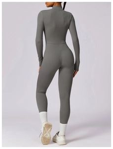 Back view of a high-stretch dark grey long sleeve yoga jumpsuit with a body-shaping fit
