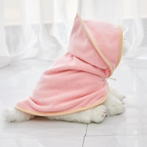 Detailed macro view of soft pink microfiber pet bathrobe fabric and hood tie string