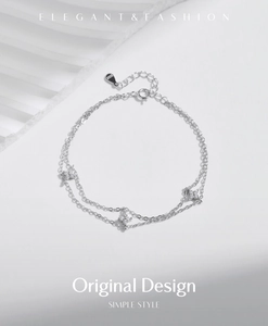 Macro view of S925 sterling silver double-layer bracelet with sparkling clover charms