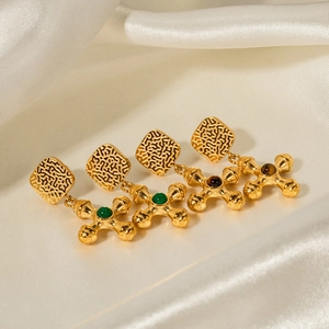 Detail of 18k gold plated stainless steel cross earrings with tiger eye stone inlays