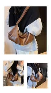 Detail view of a vintage brown crescent bag with smooth glossy PU leather and adjustable strap