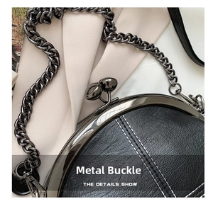 Detail of vintage metal clasp and litchi grain leather on shell chain shoulder bag