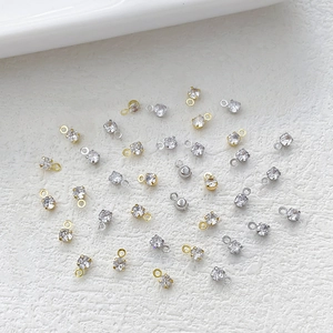 Golden and silver plated zircon pendant charms for DIY jewelry making on white background
