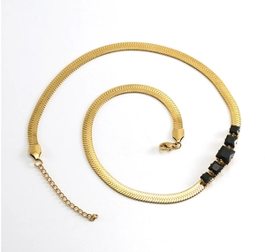 Detail of 18k gold plated flat snake chain featuring five black square-cut zircons